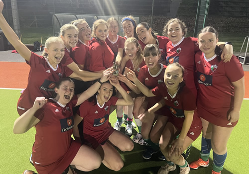 hockey team celebrating victory under floodlights